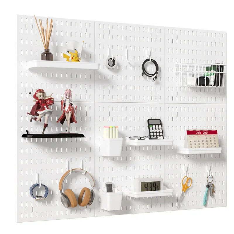 White punch-free wall board with wire-wrap loops holding cables and keys