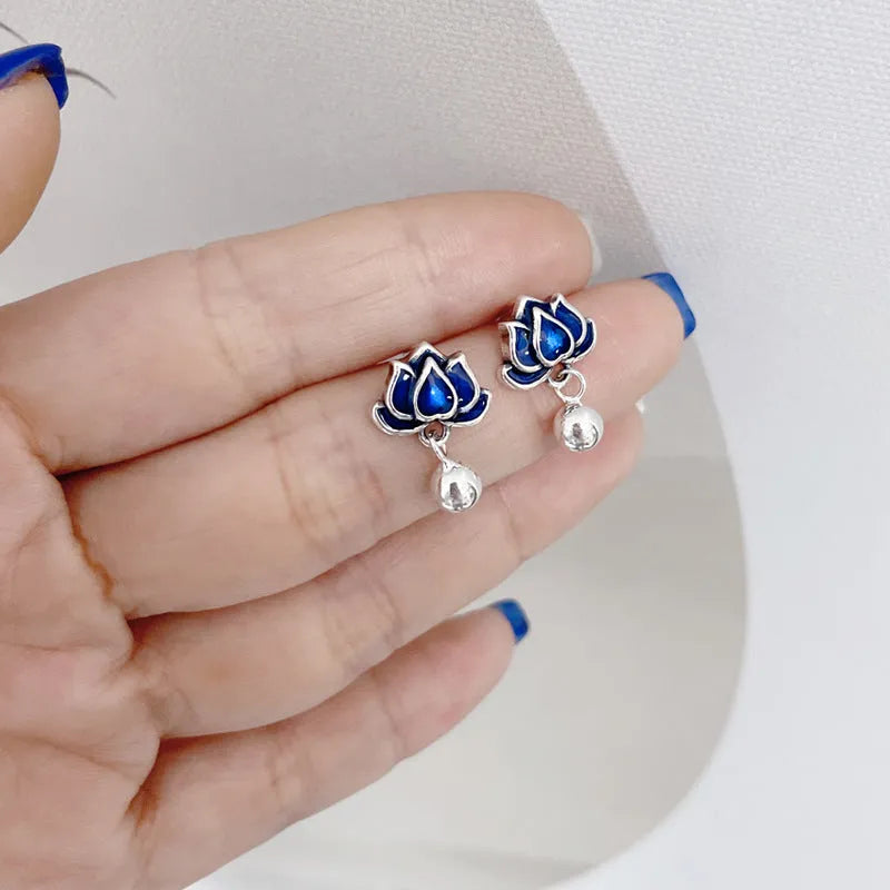 Blue lotus flower alloy ear studs with a retro seedpod tassel, shown from the front.