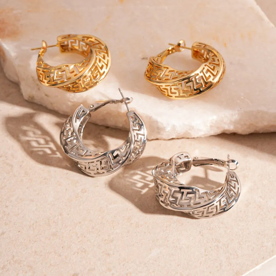 Geometric round hollow stud earrings for women with a twisted design in gold or silver finish.