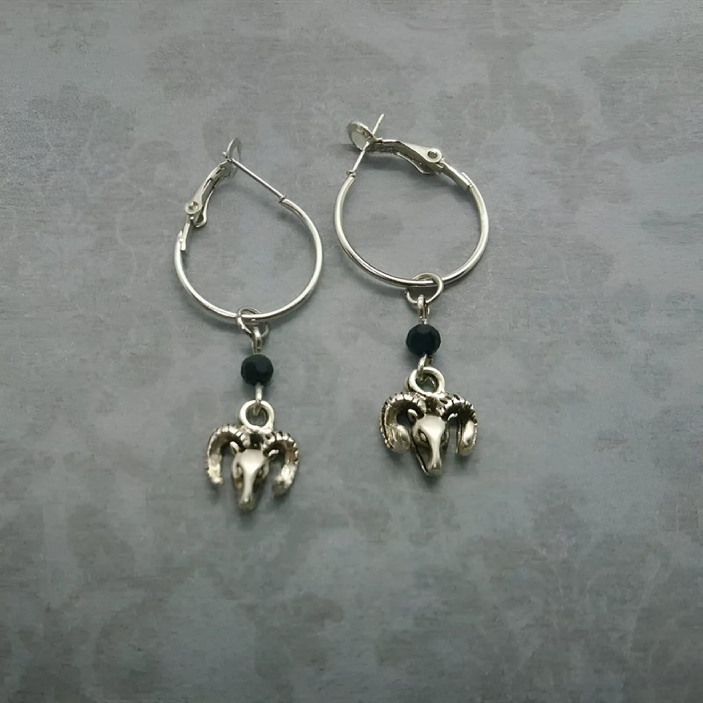 A pair of silver-coloured round ring earrings with a Tibetan Antelope inspired design.