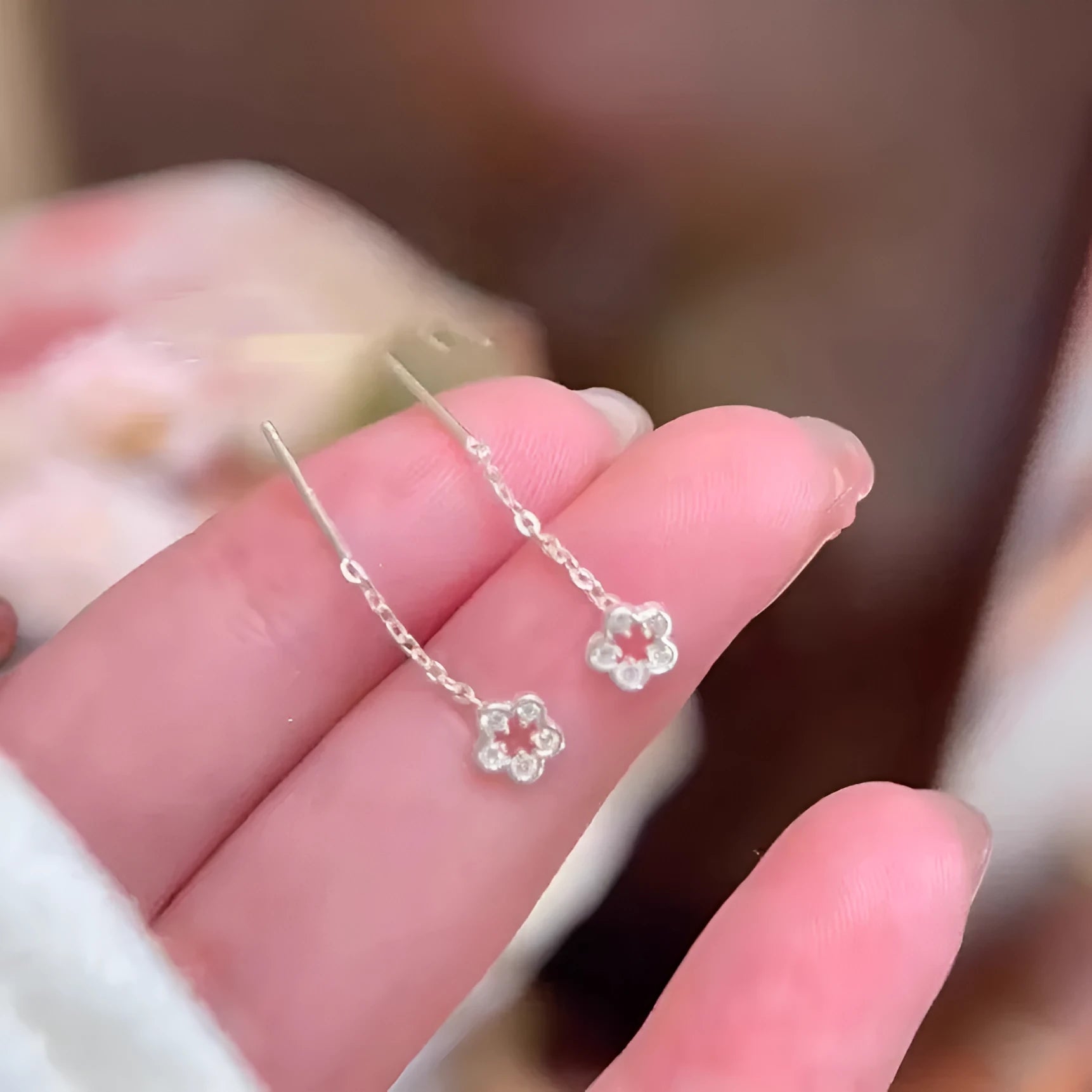 Silver hollow flower dangling earrings with petal design on sterling silver posts