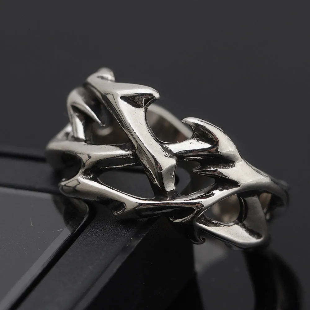 Copper thorn flower geometric ring with adjustable opening on a flat surface.