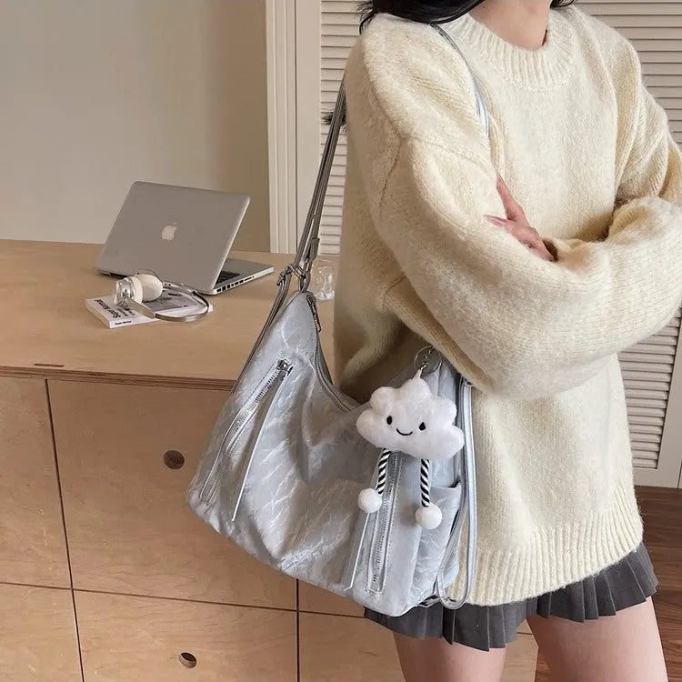 Women's soft PU leather fashion backpack in black, white, silver, or blue colour with pendant accessory