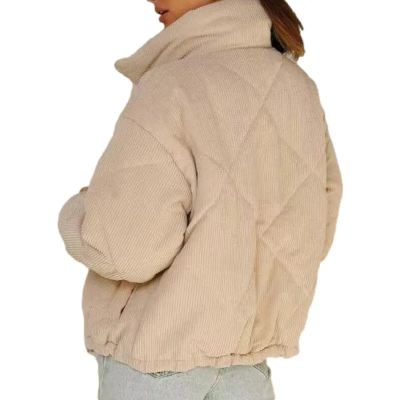 Apricot coloured women's corduroy zip jacket with stand collar and long sleeves on a hanger.