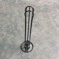 Black wrought iron coffee capsule storage rack holding 20 pods on display shelves.