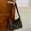 Leopard print sports style shoulder messenger bag with cross-body strap and stitching details
