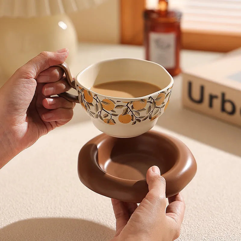 Antique style ceramic coffee cup and saucer set with medieval design in black or orange