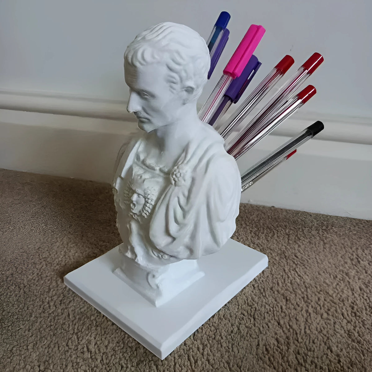 White synthetic resin statue-style pen holder with 15-pen capacity for desk storage