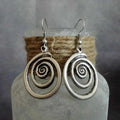 Silver alloy geometric spiral distressed drop earrings with national style, shown front-on.