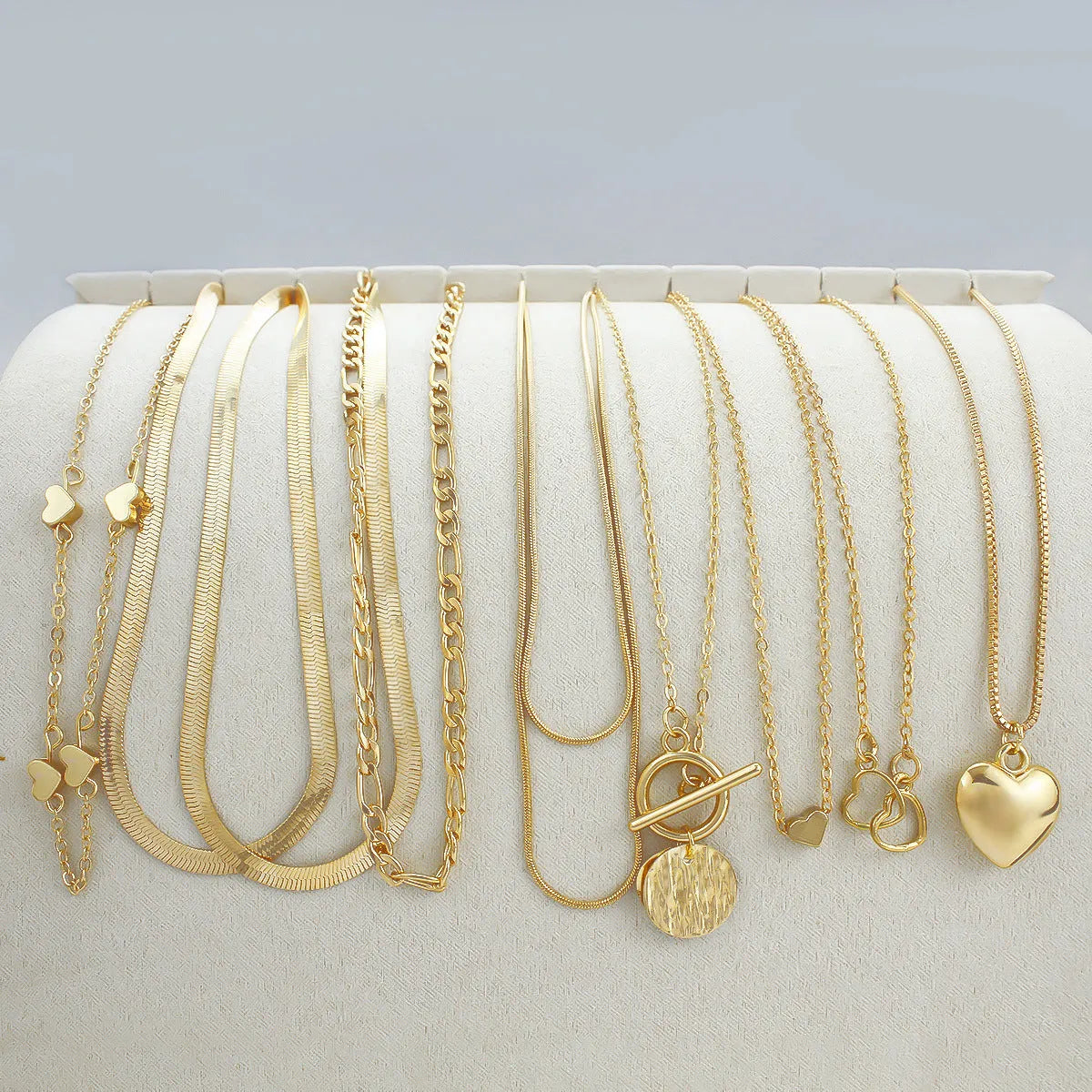 Gold electroplated women's necklace jewellery set with snake chain construction and alloy pendants