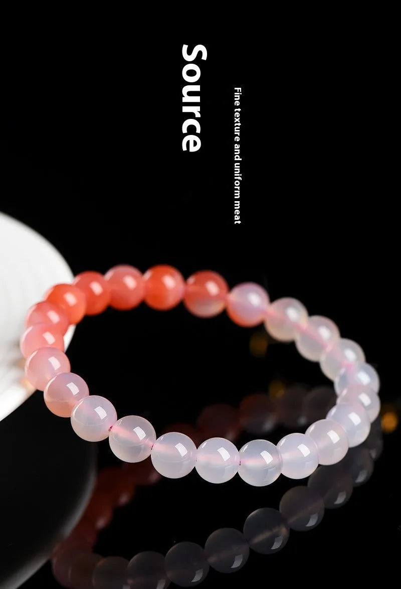 Natural gradient Yanyuan agate bracelet with geometric beads on a white background.