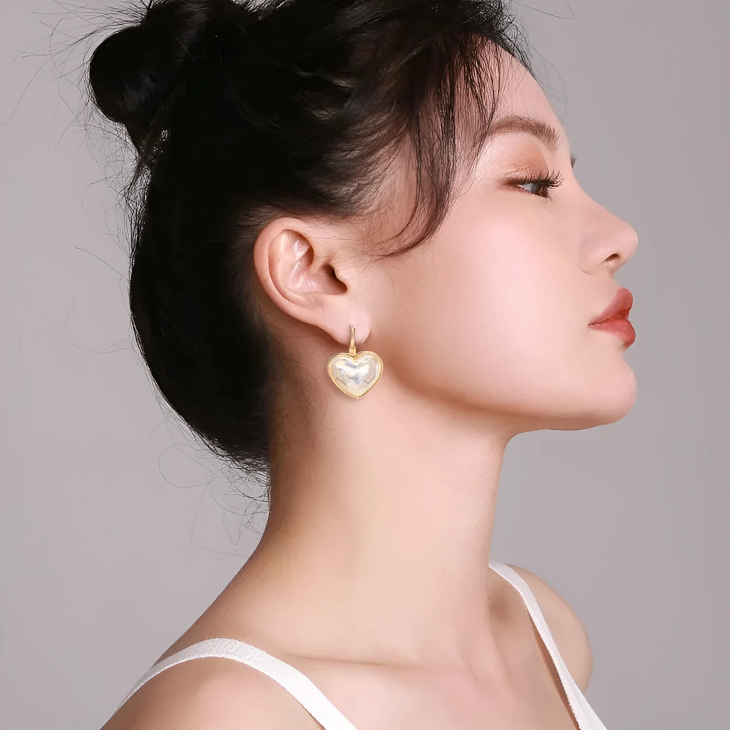 Pair of gold-coloured alloy clip-on earrings with a fashion niche design for women.