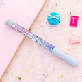 Glitter quicksand pen with 0.5mm tip in purple fairy wand style, black ink, 16cm plastic case