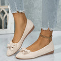 Women's beige flat casual shoes with a bowknot and shallow mouth design on a white background.