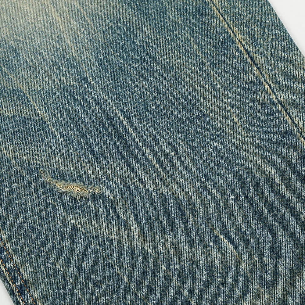 Retro distressed jeans for men in vintage blue cotton denim with worn-in finish, front view