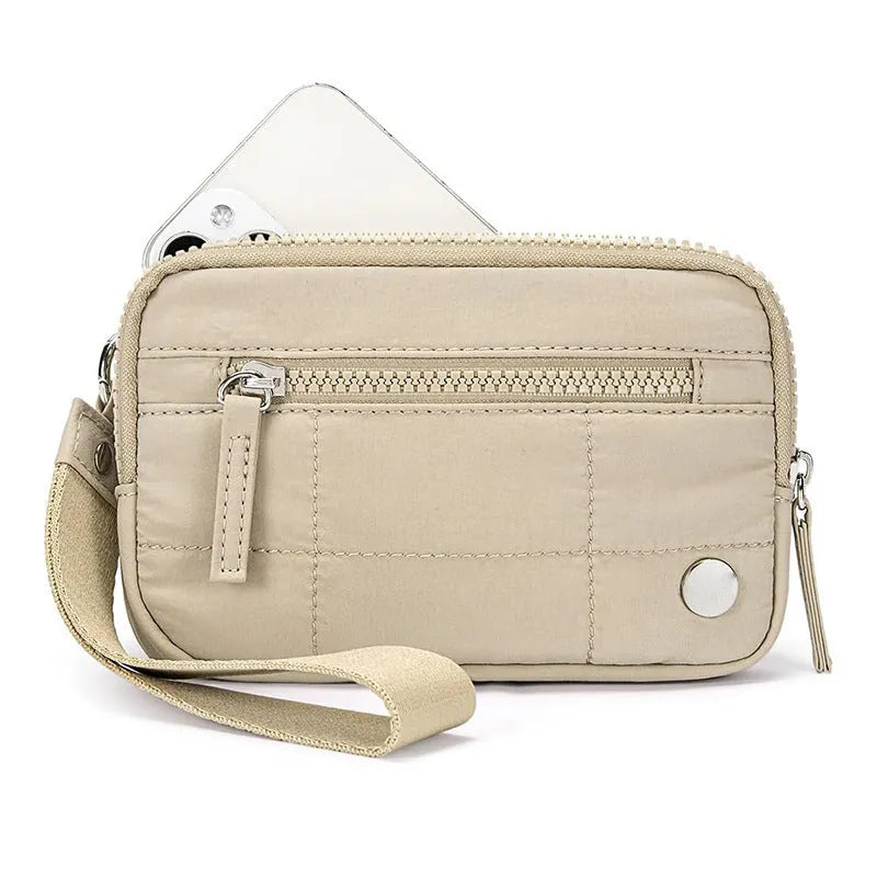 Women's waterproof quilted handbag in a light colour with a transparent front deck panel.