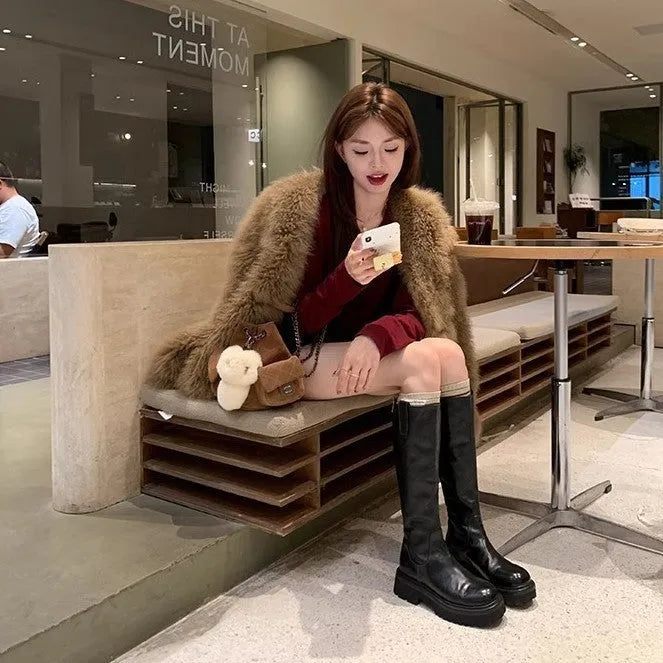 Black women's knee-high chunky heel boots with round toe and back zipper.