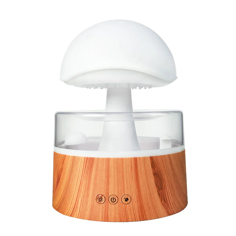 White cloud-shaped humidifier with falling raindrop mist and multi-colour night light on wooden table