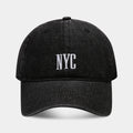 Light blue denim baseball cap with dome crown and printed alphabet letters on the front.