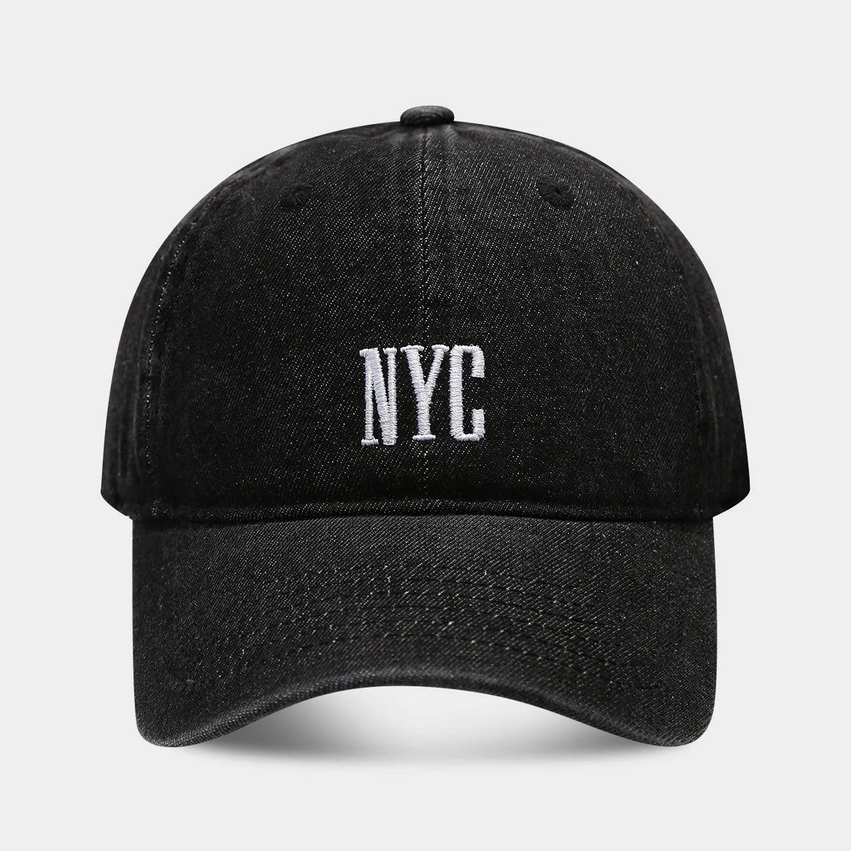 Light blue denim baseball cap with dome crown and printed alphabet letters on the front.