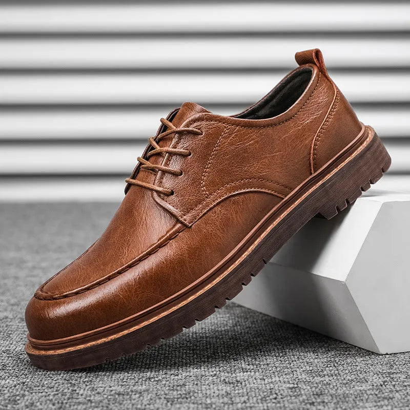 Men's black and brown low top casual leather shoes with round toe and rubber sole.