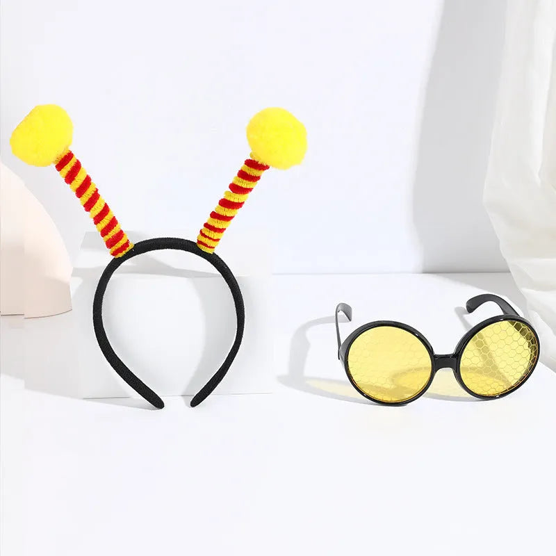 Yellow children's fancy dress set with bee motif headband and matching insect glasses.
