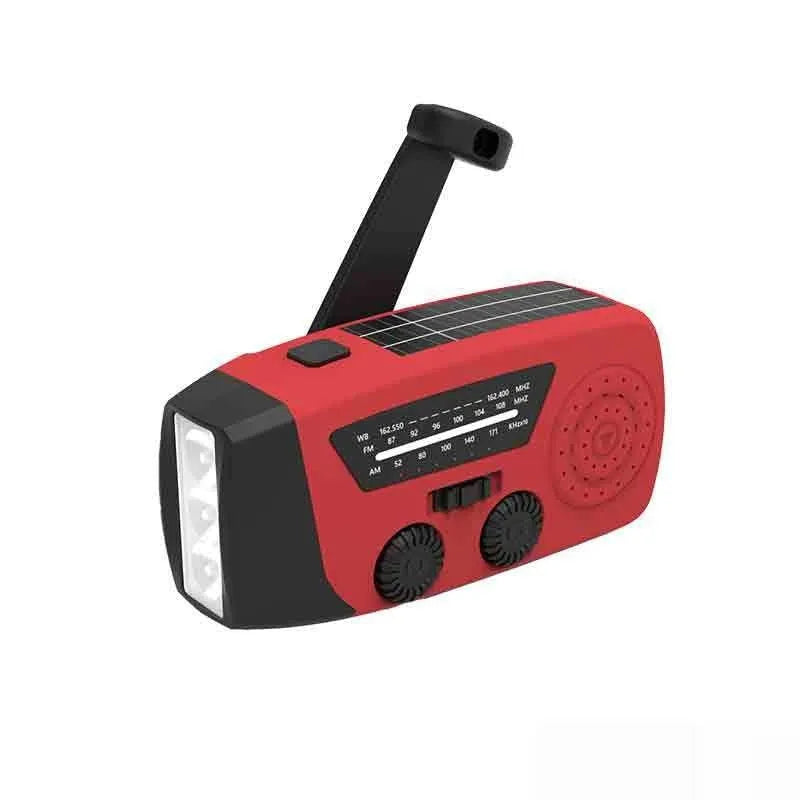 Red rechargeable hand-held radio with emergency torch, USB port, speaker, and wrist strap.