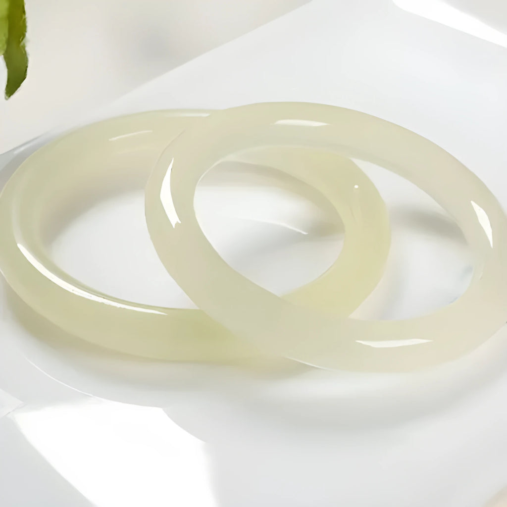 Adjustable winding bracelet made of round ice-like silk jade beads on a silk cord.