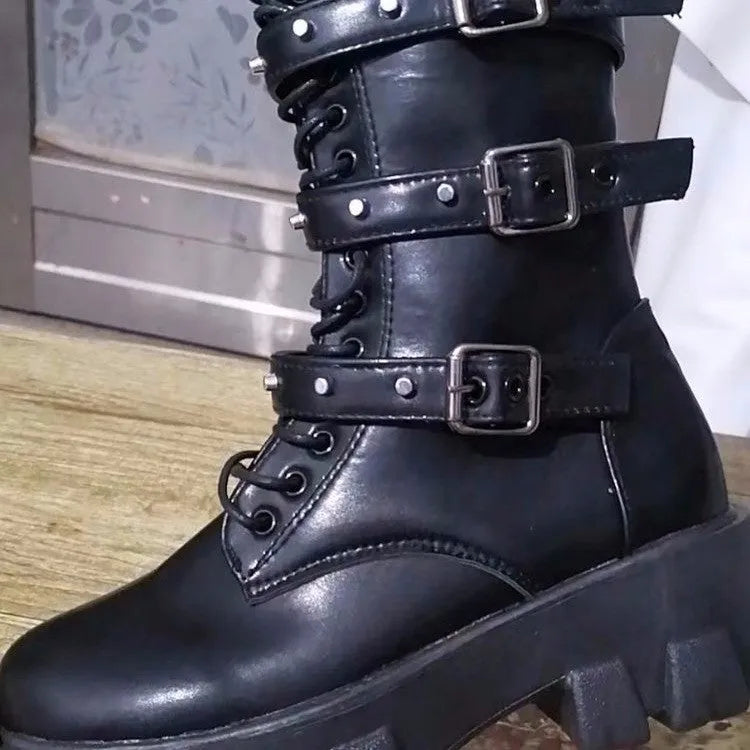 Black mid-calf women's boots with a large metal buckle and side zip on a white background.