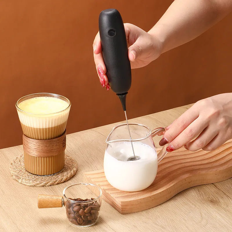 Black and white hand-held electric milk frother blender with modern design