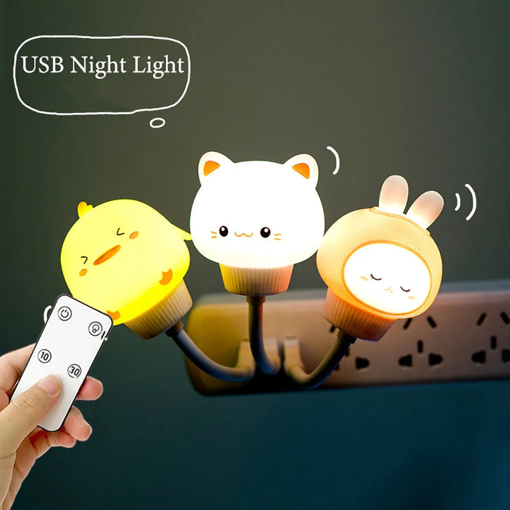 Cartoon animal USB portable LED night light with remote control on a bedside table.
