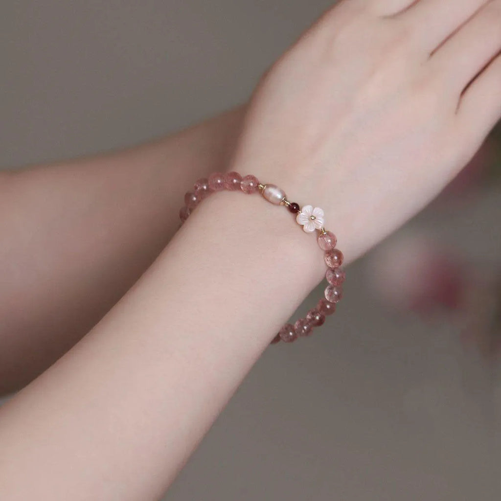 Strawberry quartz crystal bracelet with flower-shaped design on adjustable band for women
