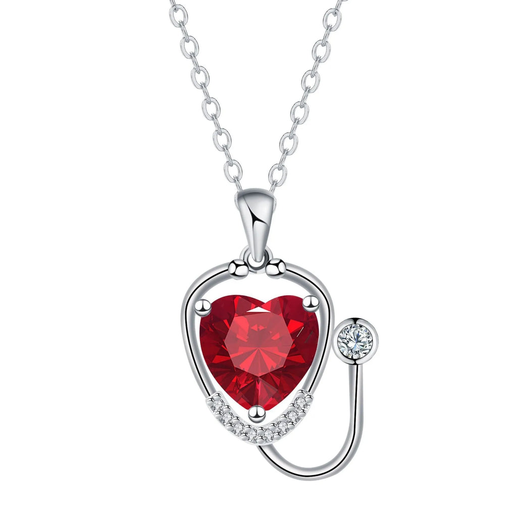 Women's fashion necklace with stethoscope, wings and cross design in red diamond colour