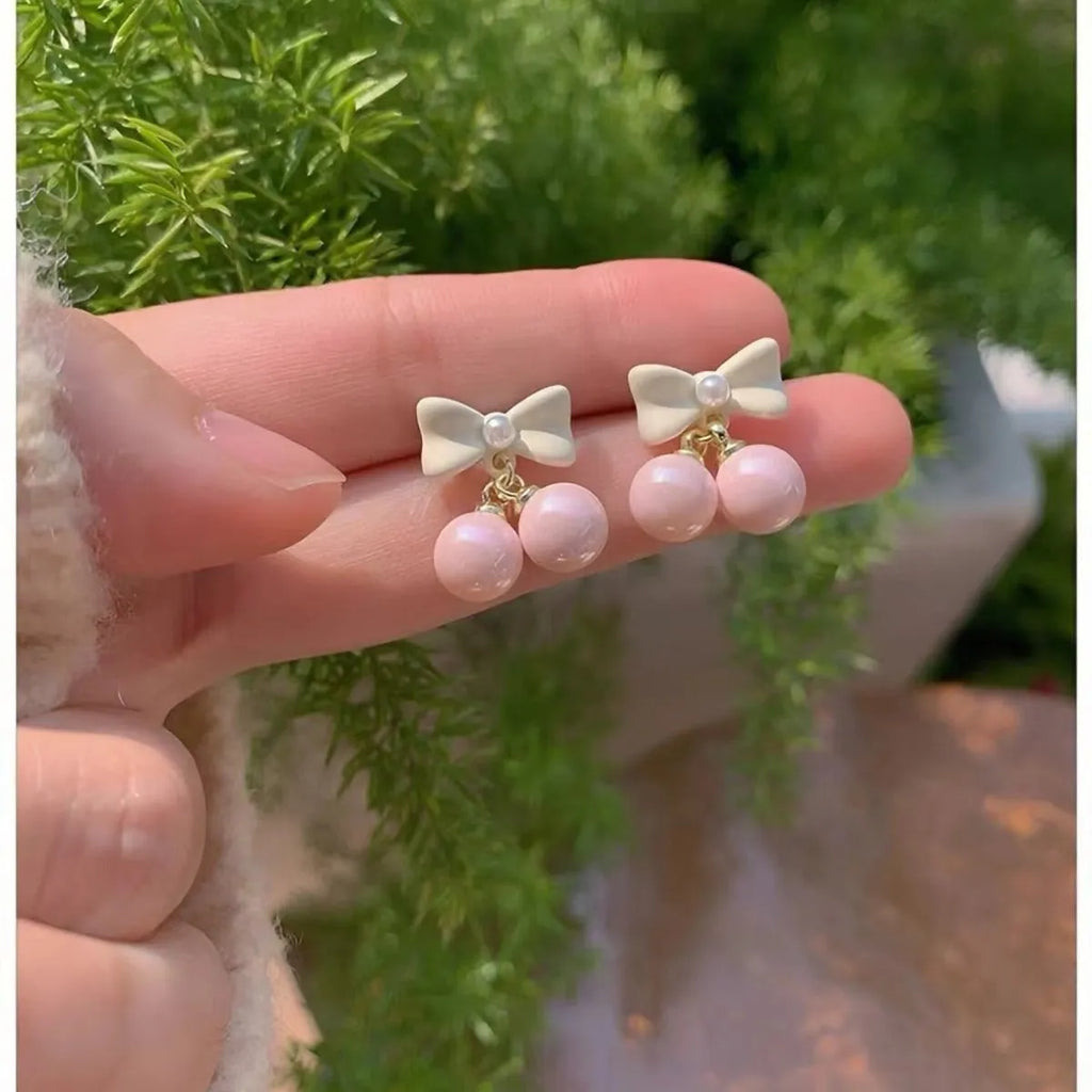 Pink alloy women's earrings with heart, pearl, and bow design, electroplated finish, sold as one pair