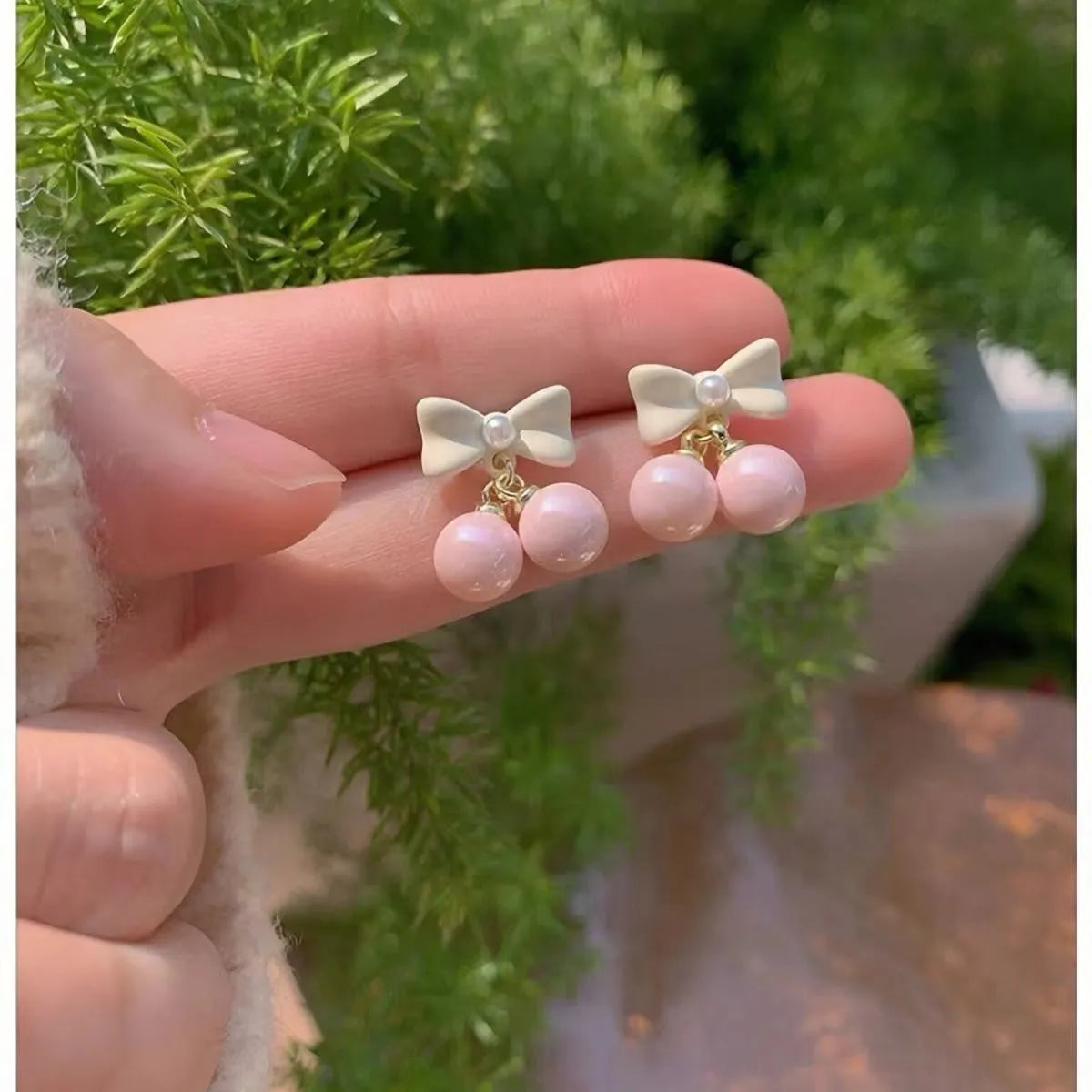 Pink alloy women's earrings with heart, pearl, and bow design, electroplated finish, sold as one pair