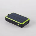 Orange hand solar mobile power bank showing USB ports, solar panel, and hand charging mechanism
