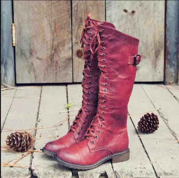 Women's black chunky heel high leg boot with a round toe and rubber sole.