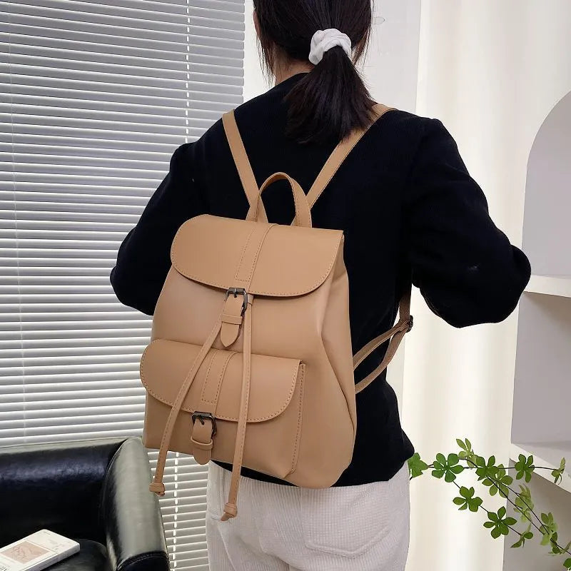 Retro college style small PU bucket bag in khaki with clamshell opening and multiple interior pockets