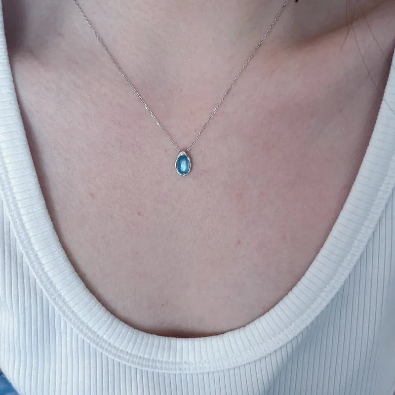 Navy blue water drop necklace with geometric pendant on copper cross chain, platinum-colour electroplating