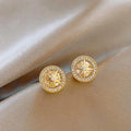 Pair of copper stud earrings with real gold plating and inlaid zircon in an eight-pointed star shape for women