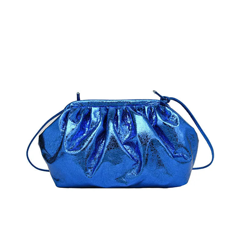 Shell-shaped PU leather crossbody bag with hair clip closure showing internal phone and document compartments