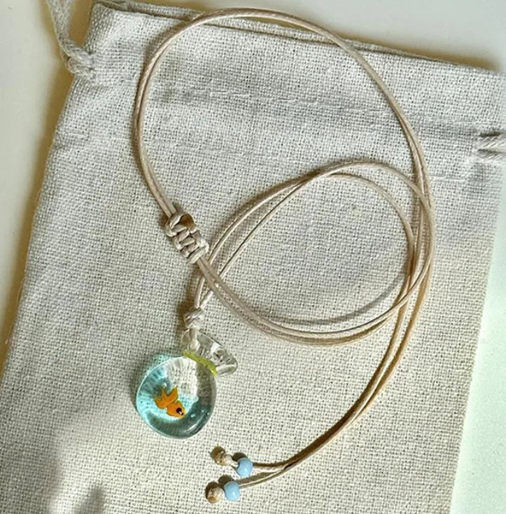 Women's pendant necklace with coloured glaze charm on a cotton and linen clavicle chain in Small Fish Lucky Bag colour.