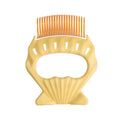 Shell-shaped plastic pet grooming brush with bent wire bristles and anti-slip handle in green colour