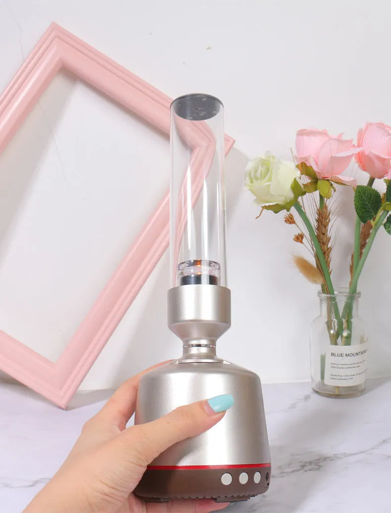 White silver cylindrical Bluetooth speaker with candlelight night light, 27.7 cm tall