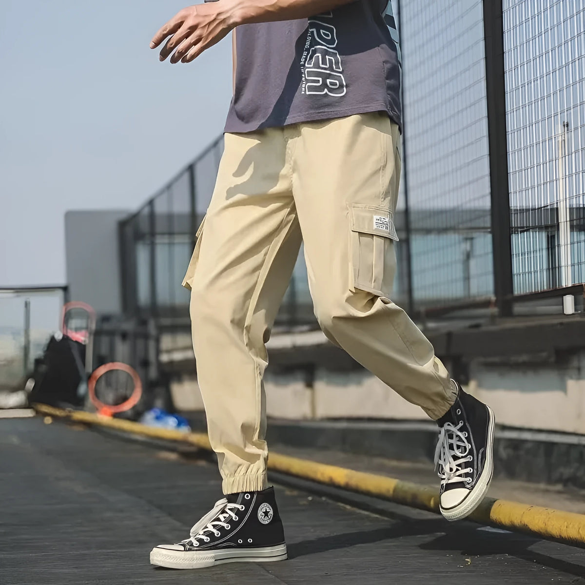 Khaki multi-pocket harem trousers with tapered mid-waist and elastic waistband, polyester fabric