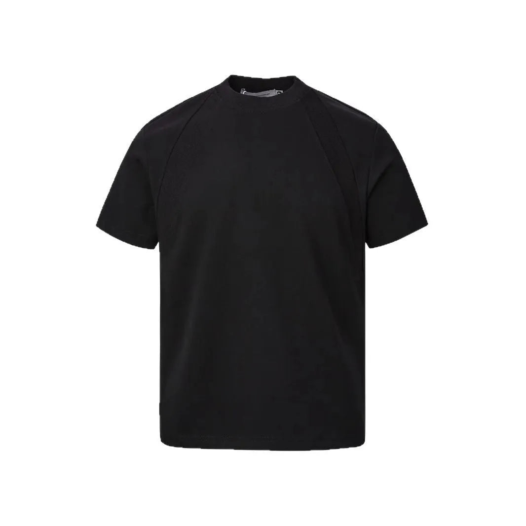 Men's loose black short sleeve top with textured air layer stitching on a grey background