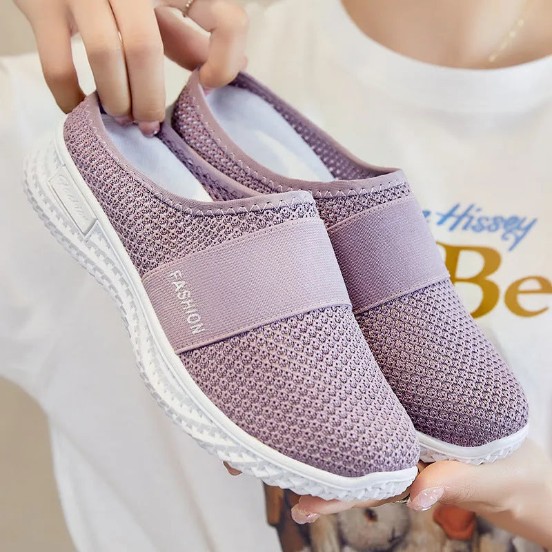 Women's black mesh casual flat shoes with hollow out design and round toe.