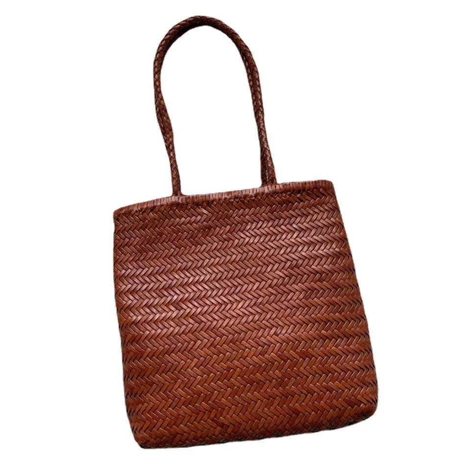 Woven vintage cowhide leather tote bag with three-dimensional outer pockets showing brown colour