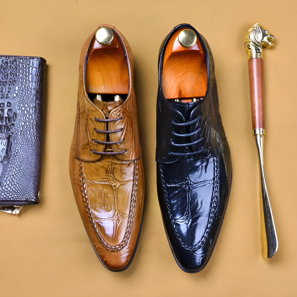 Men's black leather shoes with alligator pattern texture and a silver horse bit buckle on the front.