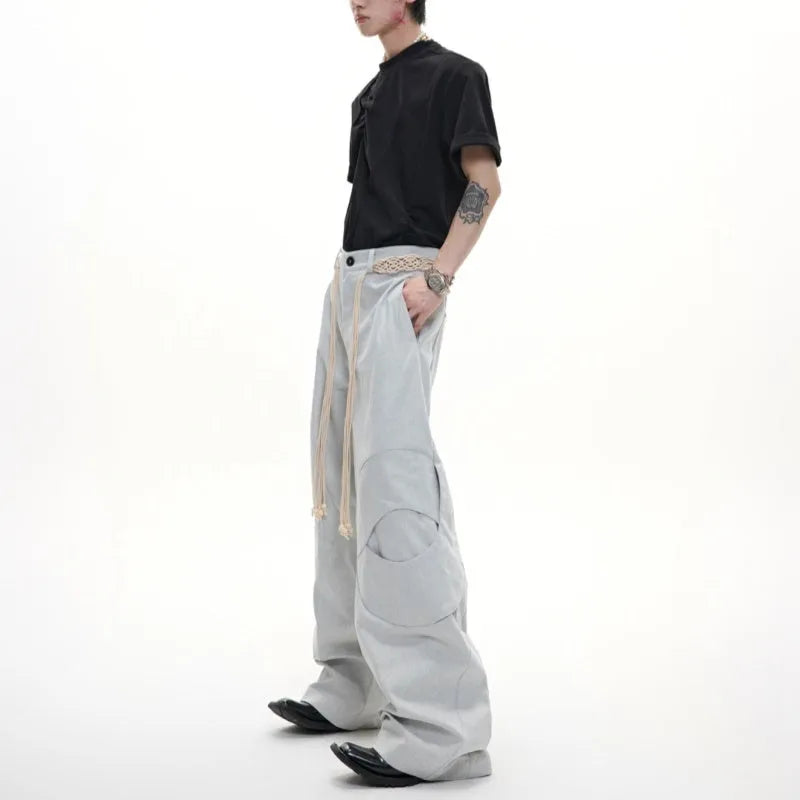 Men's heavyweight cotton straight-leg jeans with 3D cutting, decorative zipper details, and tassel accents in dark colours